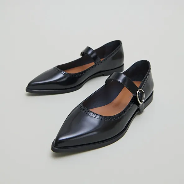 Ballet flats with pointed toes in black glazed leather